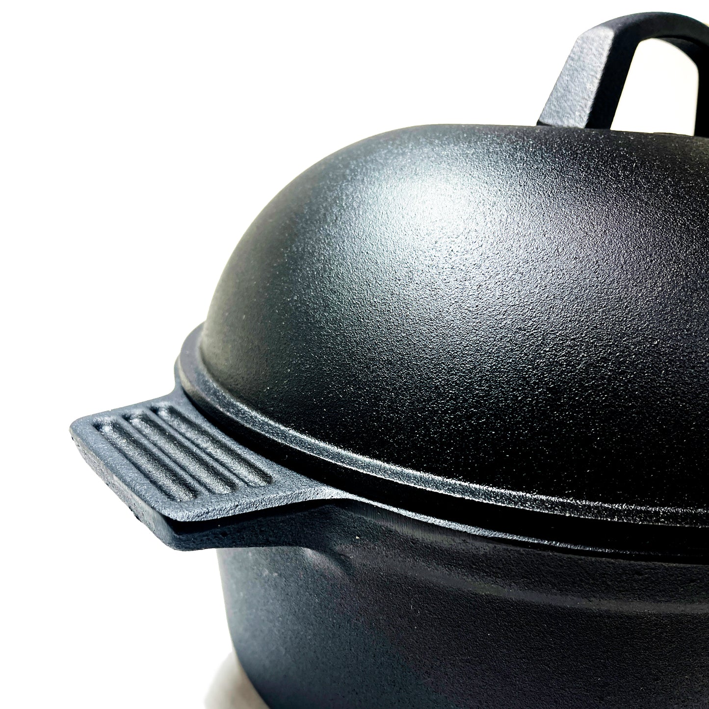 Close up of oval roaster with lid on a white background