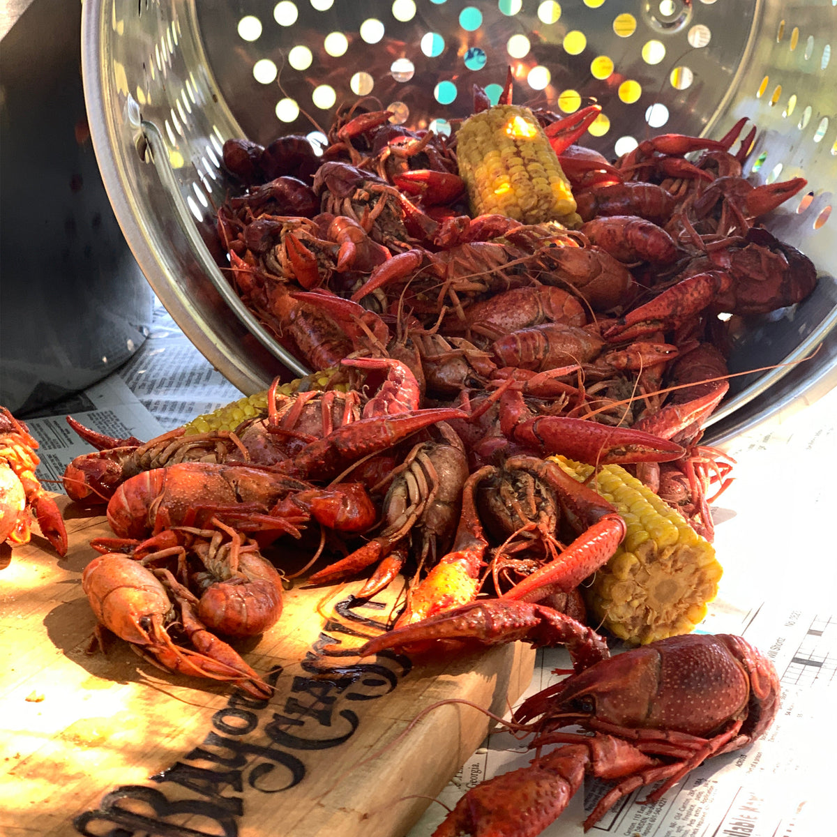 Stainless Basket dumping crawfish on a table