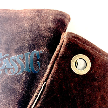Close up of brown brushed leather gloves with grommet detail on a white background
