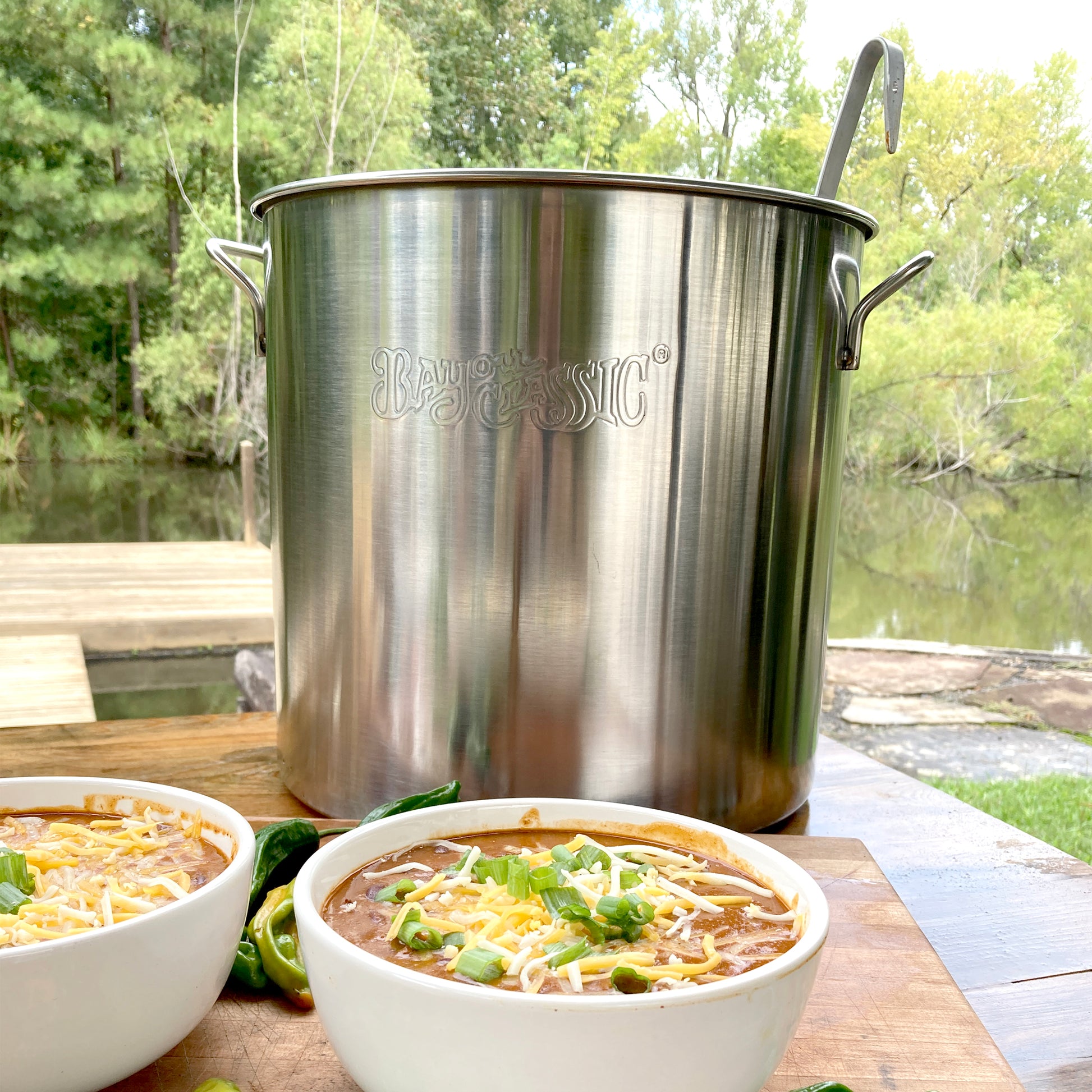 40-qt Stainless Stockpot with chili in bowls in an outdoor setting
