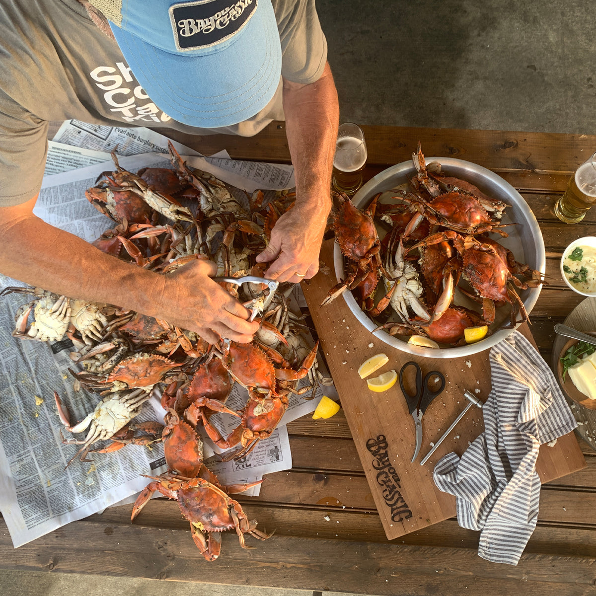 Overview of person cracking crabs on a table