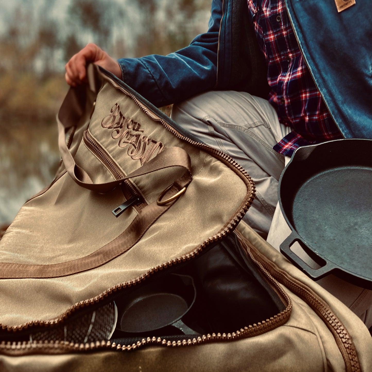 Close up of gear bag featuring heavy brown zippers and Bayou Classic logo