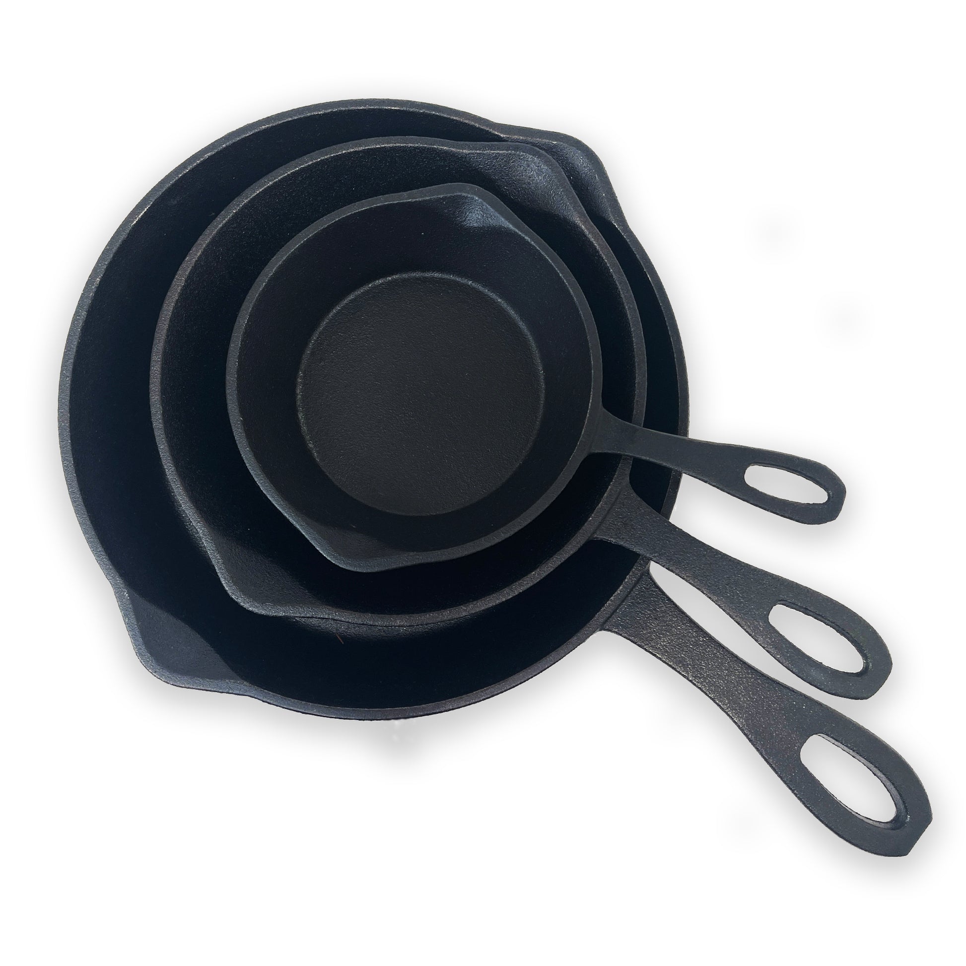 A set of three black cast iron skillets, stacked from largest to smallest, with pour spouts and handles on a white background.