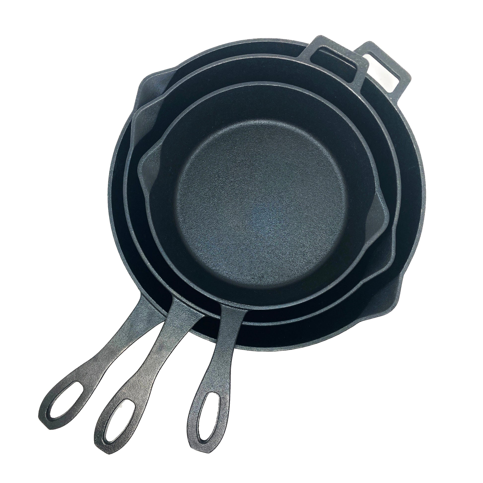 A set of three black cast iron skillets with handles, stacked together, in varying sizes on a white background