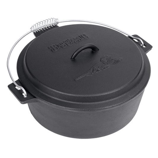 A black cast iron chicken fryer with a domed lid and coiled wire handle on a white background