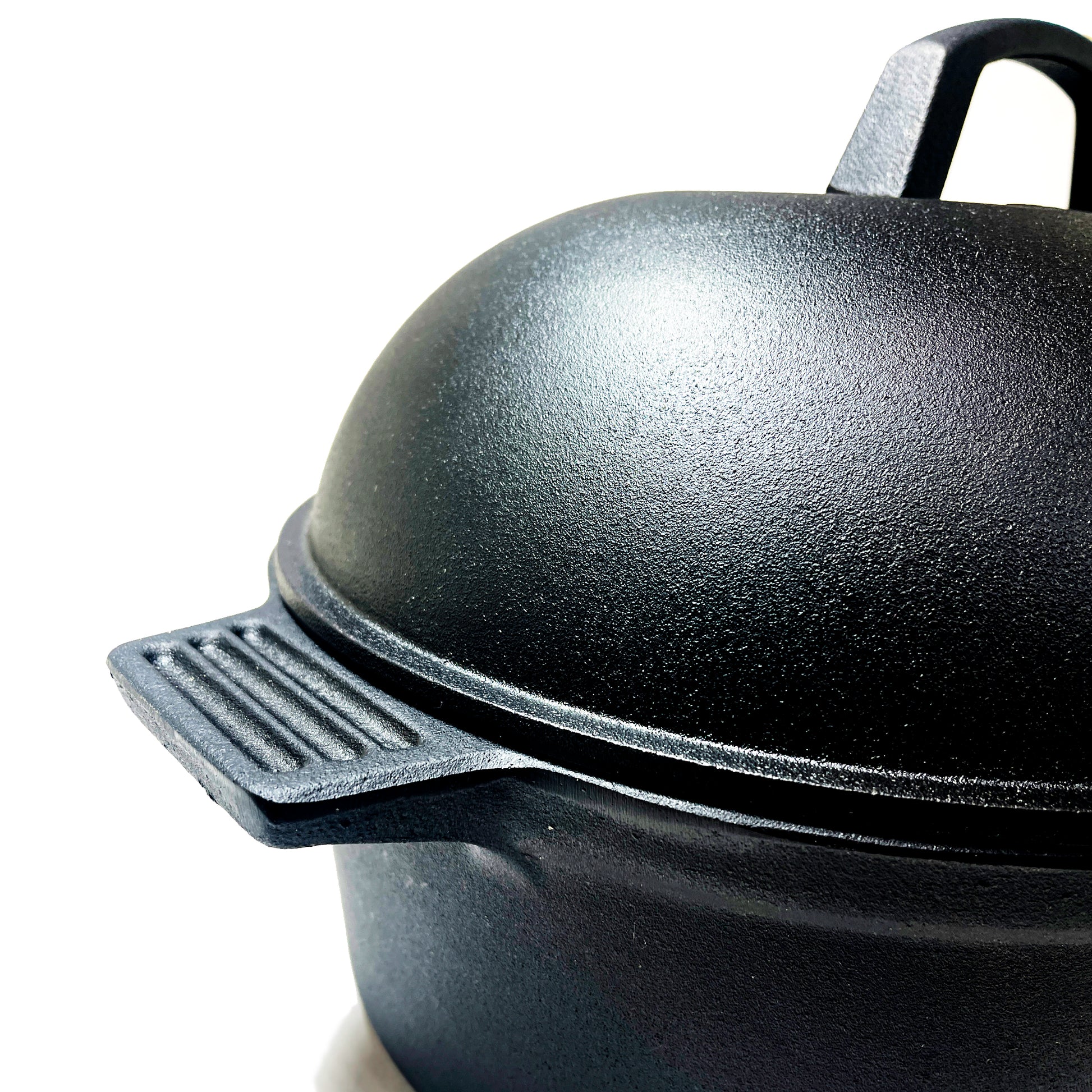 Close up of oval roaster with lid on a white background
