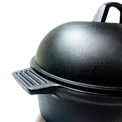 Close up of oval roaster with lid on a white background