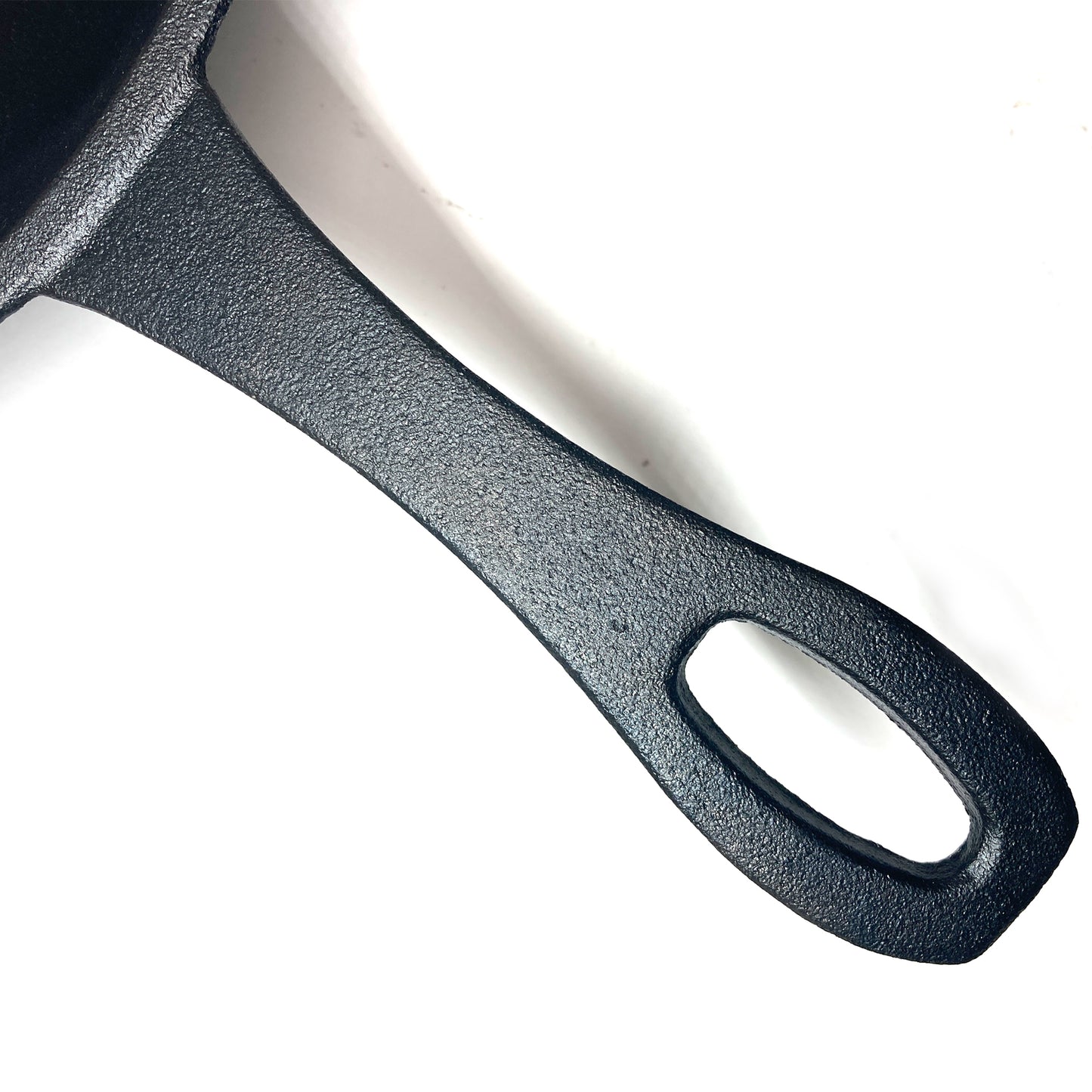 Close up of Cast Iron Skillet handle on a white background