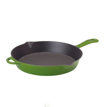 Green enameled cast iron skillet on a white background