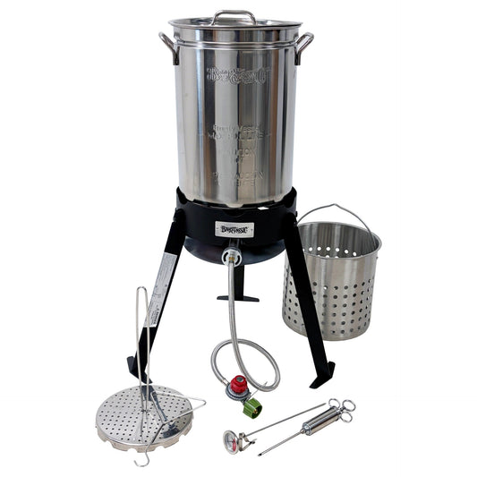 A stainless steel outdoor turkey fryer on a black tripod cooker, including a basket, poultry rack, grab hook, thermometer, and injector on a white background.