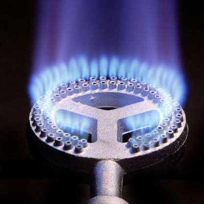 Close-up of a gas burner with blue flames on a black background