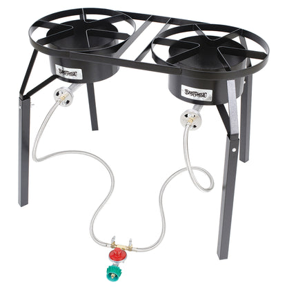 A dual burner high pressure cooker with two cast aluminum burners, stainless steel braided LPG hoses, and a black welded steel frame on a white background.