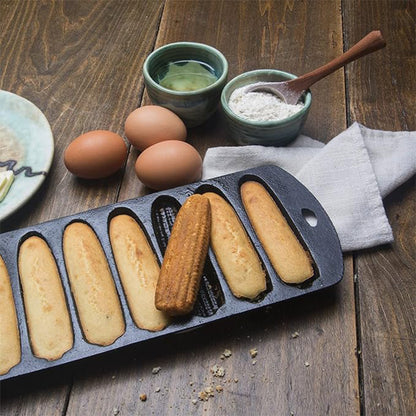 Cooked cornbread in a cast iron cornbread pan with corn stick shaped molds and fresh ingredients