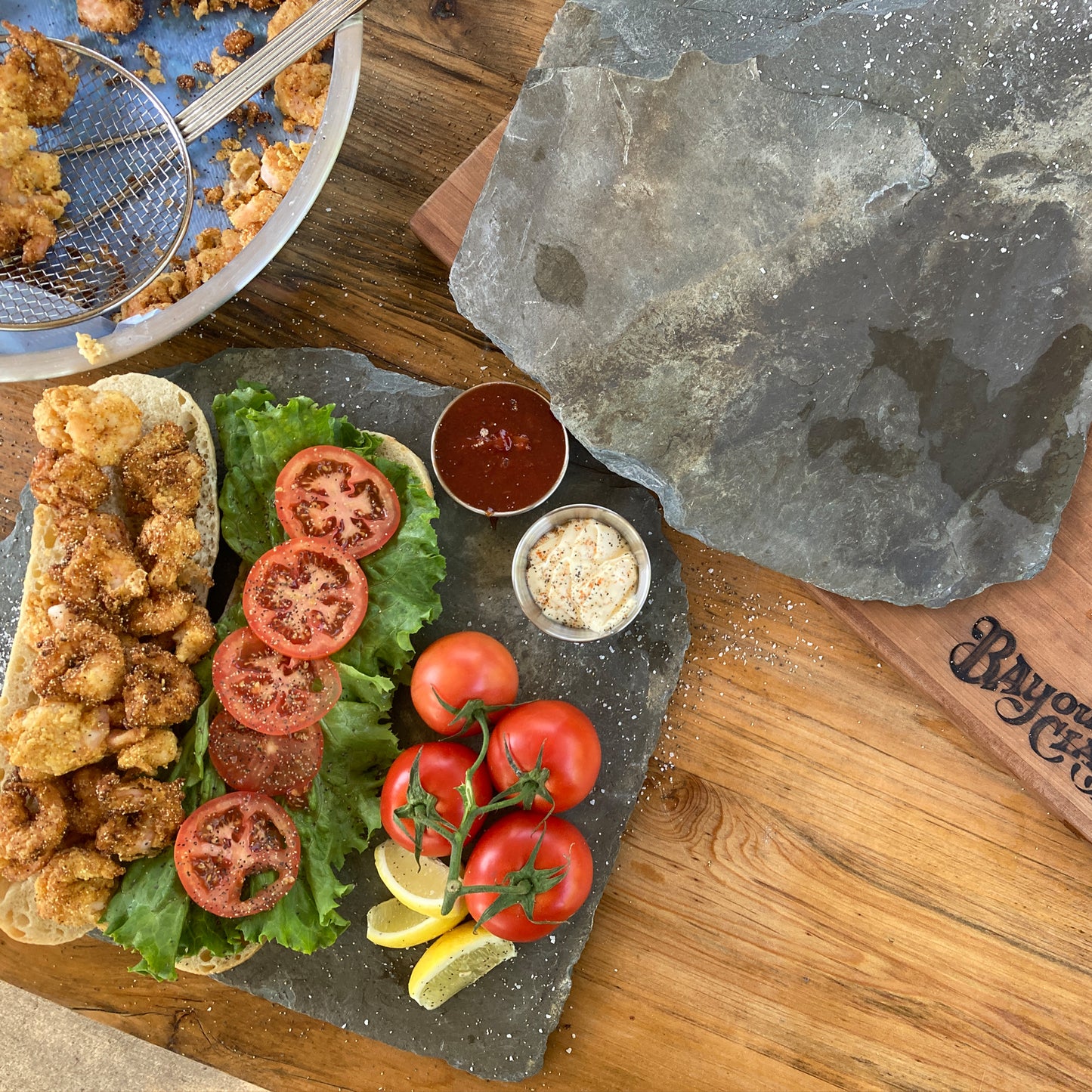 Open faced fried shrimp poboy with fresh ingredients