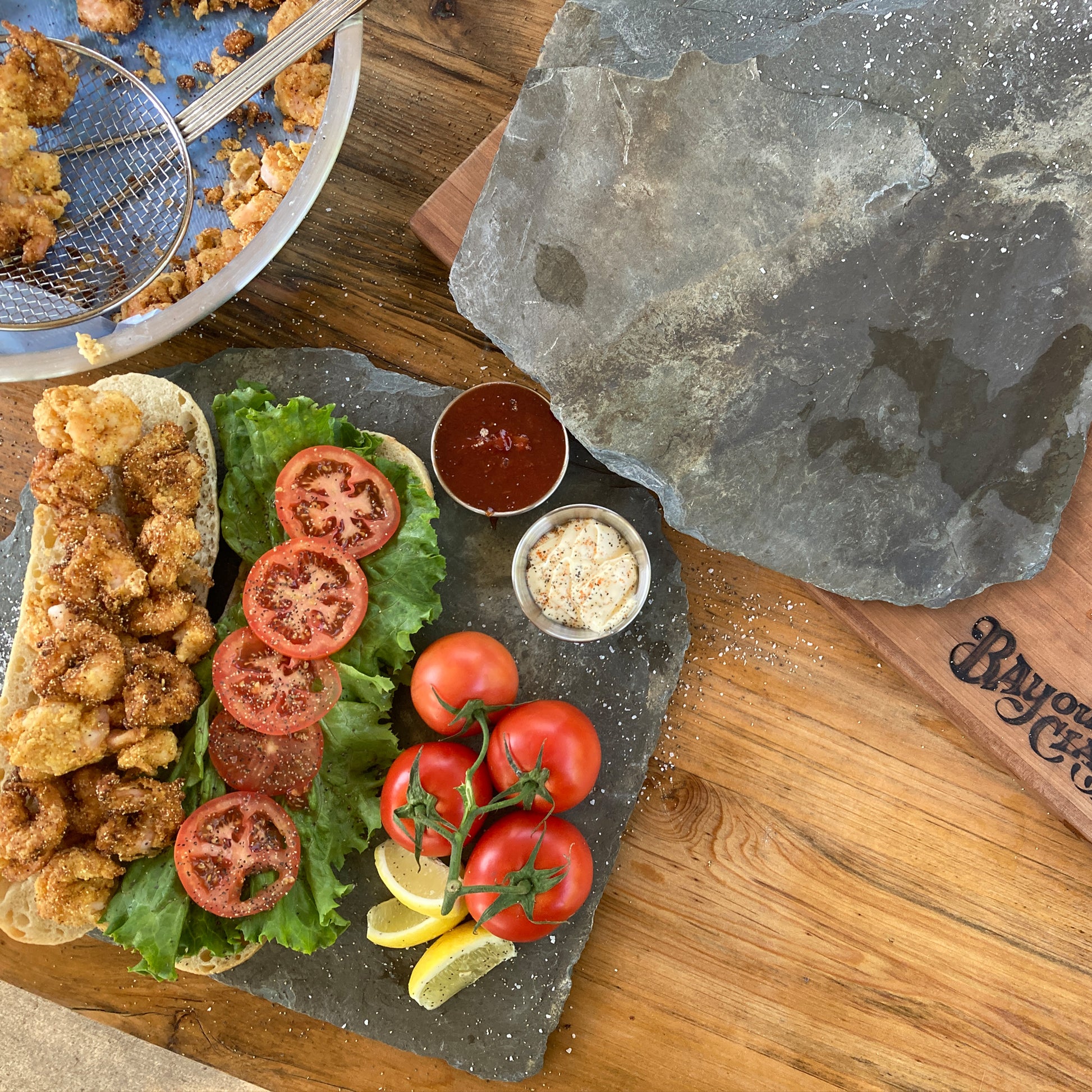 Open faced fried shrimp poboy with fresh ingredients