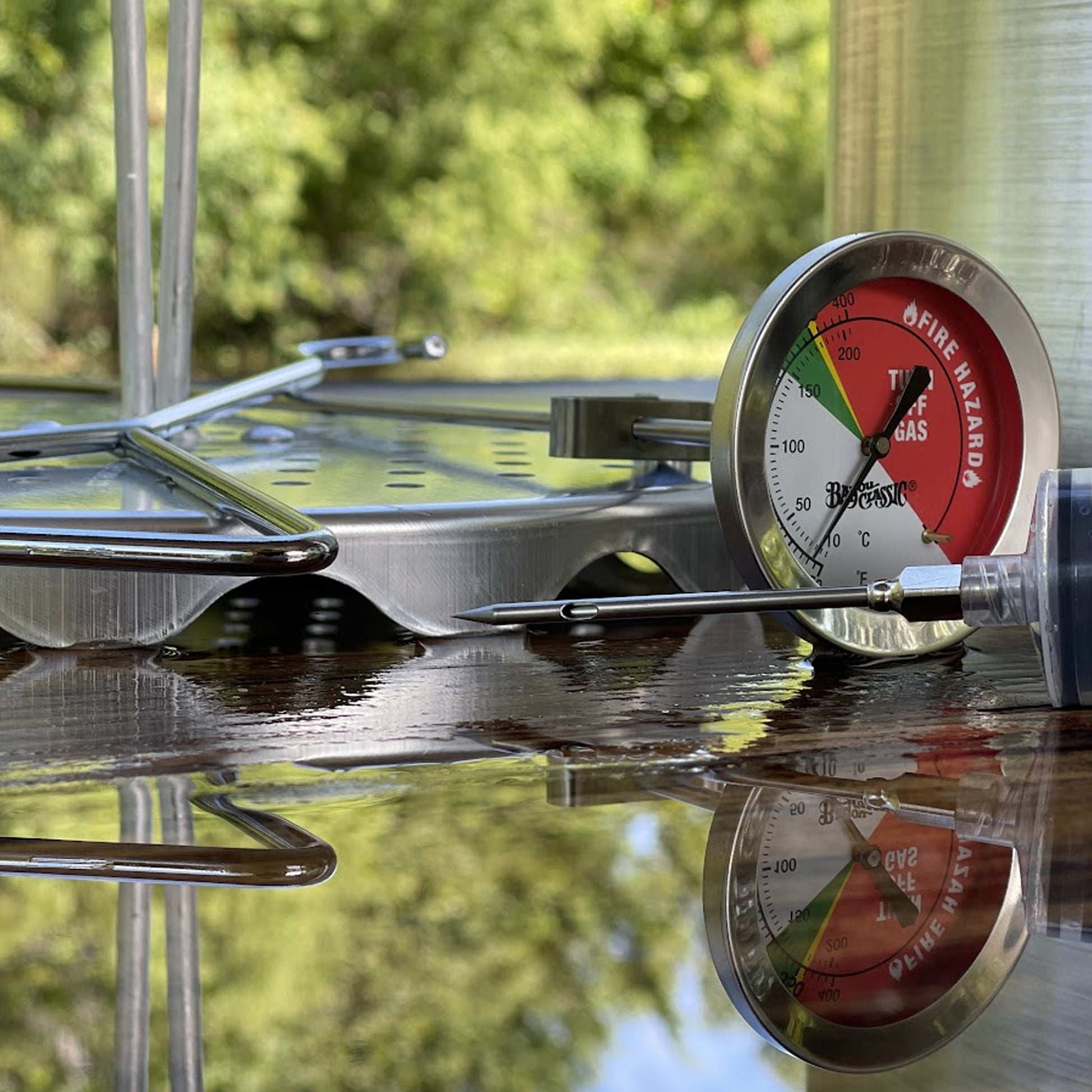 Deep fry thermometer outside with other cooking accessories.