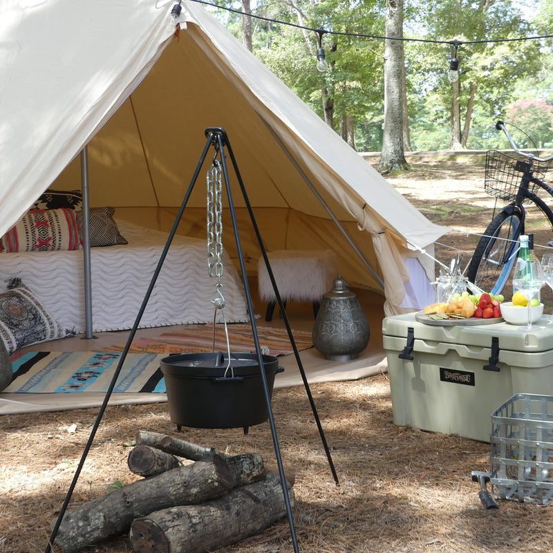 Glamping Campsite with a tent, cast iron pot, firewood, and a cooler
