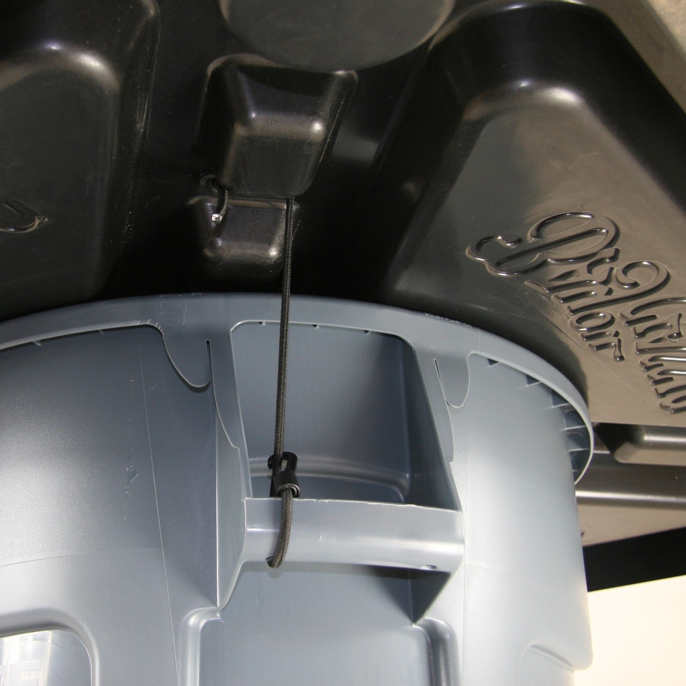 Bottom image of seafood table showing how it uses included bungee cords to attach to garbage can handles