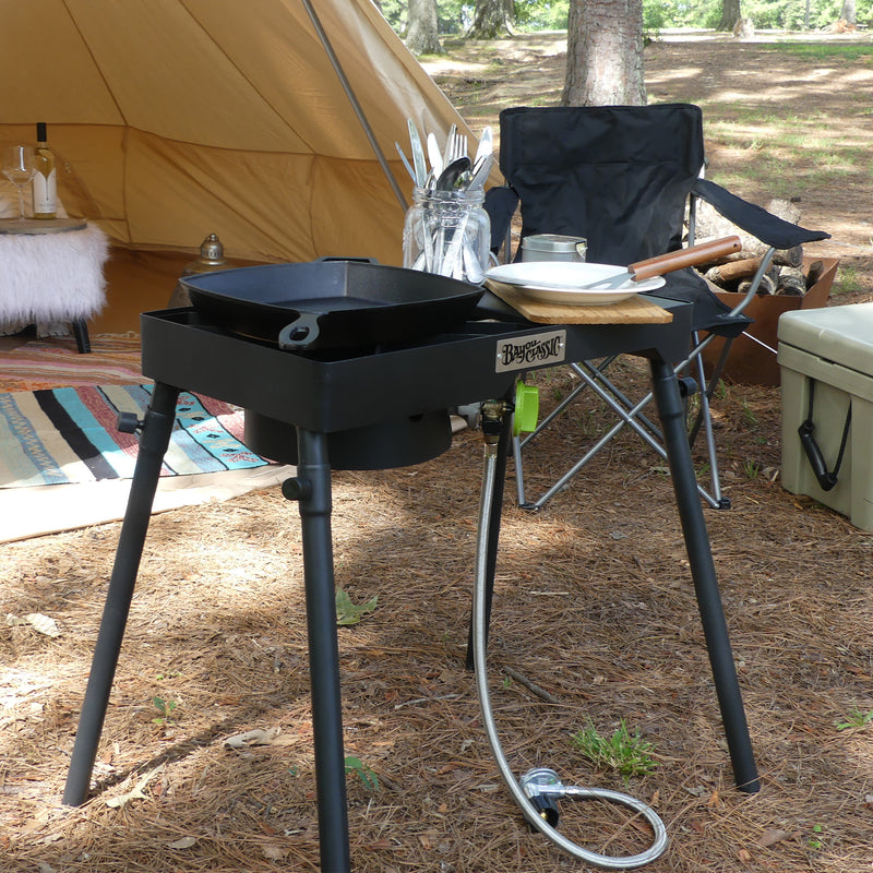 Patio Stove with a cast iron griddle outside at a camp site