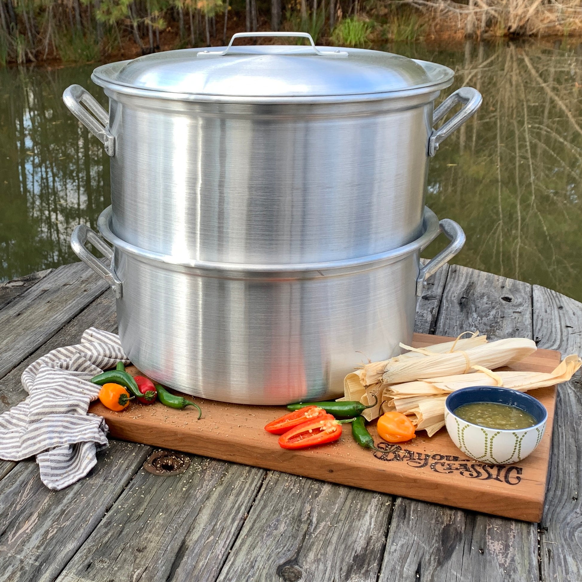 Aluminum steamer with ingredients to make tamales in an outdoor setting